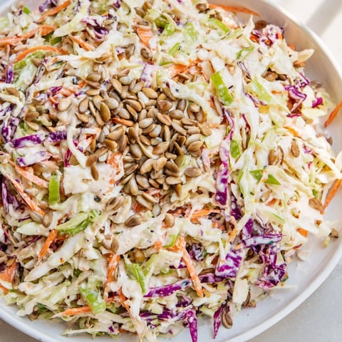Fresh and flavorful crunchy coleslaw salad, bursting with colorful veggies and creamy dressing, ready to eat.