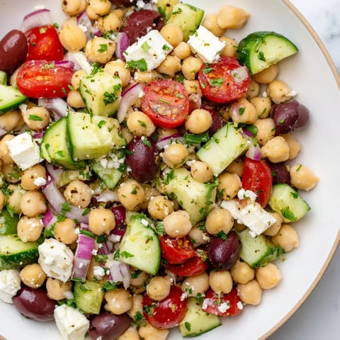 Mediterranean Chickpea Salad bursting with color, featuring chickpeas, cucumbers, and tangy feta cheese.