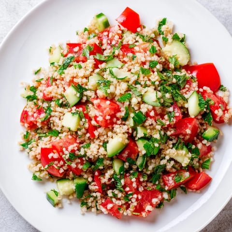 A close-up of vibrant Bulgur Wheat Salad Tabbouleh, bursting with fresh herbs and colorful vegetables.