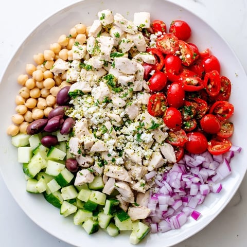Vibrant Mediterranean Chickpea Chicken Salad brimming with colorful tomatoes and creamy feta cheese, ready to enjoy.