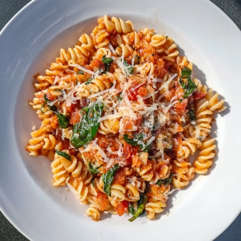 Golden-lit photo of Tomato Spinach One-Pot Rotini, a flavorful vegetarian main dish.