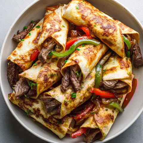 A plate of keto Philly cheesesteak roll ups.