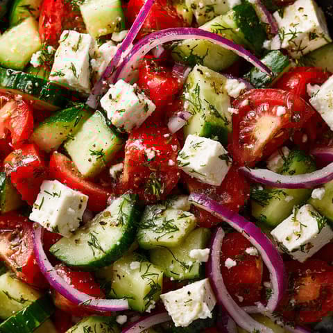 A salad of cucumbers and tomatoes with feta cheese.