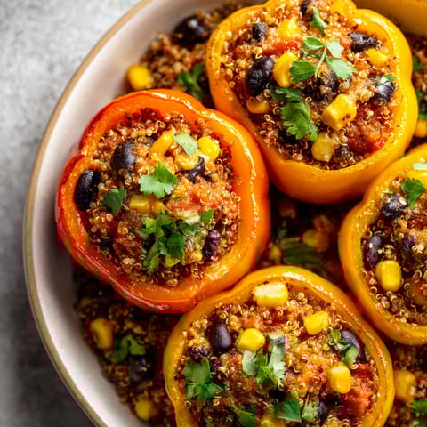 A plate of food with peppers and corn.