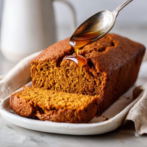 A slice of bread with honey drizzled on it.