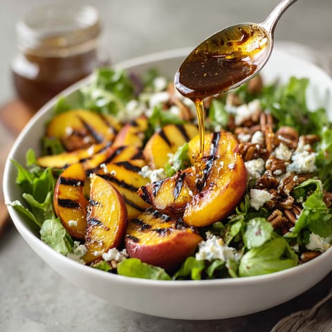 A bowl of salad with peaches and blue cheese.