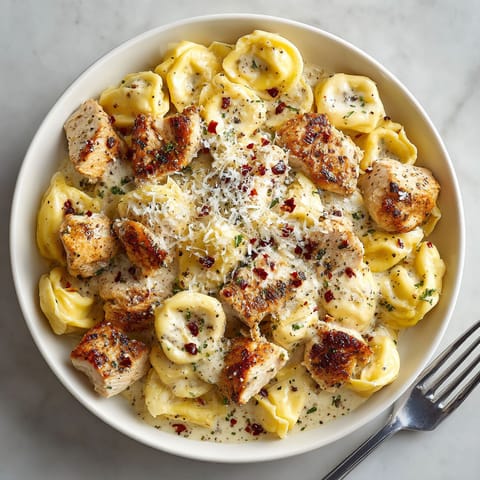 A plate of food with chicken and pasta.