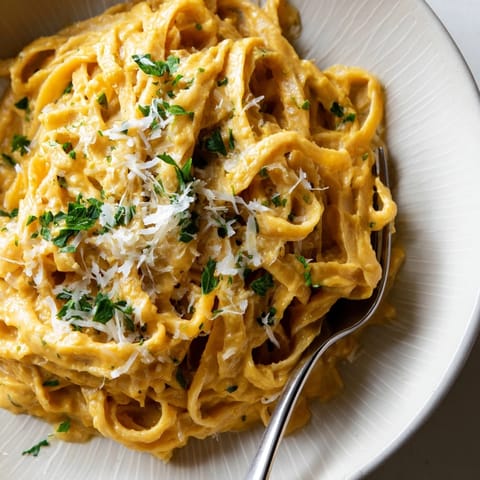 Savory Pumpkin Alfredo Pasta Skillet: close-up of cheesy, parmesan-topped perfection, steaming hot from the skillet.