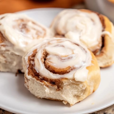 Warm, gooey Viral TikTok Heavy Cream Cinnamon Rolls with cream cheese icing, perfect for a cozy brunch.