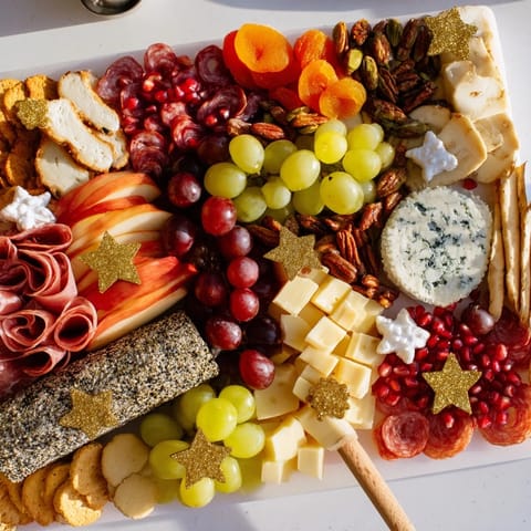 Shining Bright Christmas 2025 Board: a vibrant, colorful grazing board overflowing with holiday cheeses and fruits.