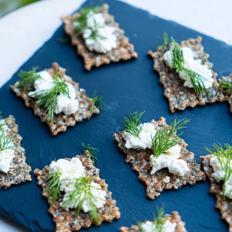 Creamy white cheese “whitecaps” atop dark grey crackers create an elegant The Stormy Sea plate.