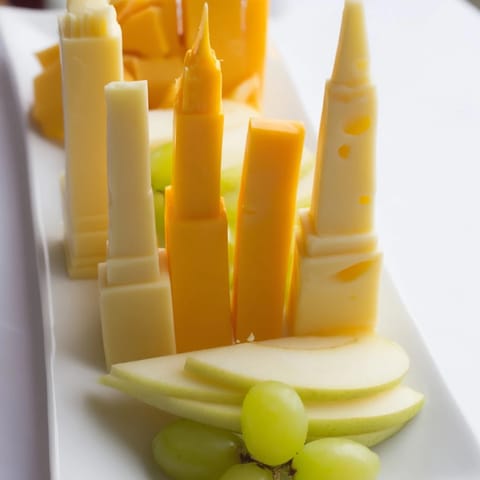 This Skyline Silhouette appetizer features cheese cut in building shapes, ready to pair with crackers.