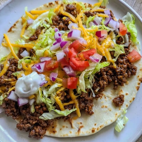 See the savory, crispy edges of the Smash Tacos, loaded with fresh toppings, ready to eat!