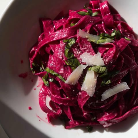 Close-up of freshly cooked Beet Noodle Pasta, showcasing its beautiful natural magenta coloring.