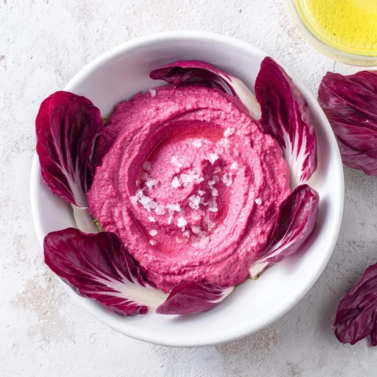 Earthy beet hummus, the heart of The Velvet Rose, artfully piped and surrounded by fresh radicchio.