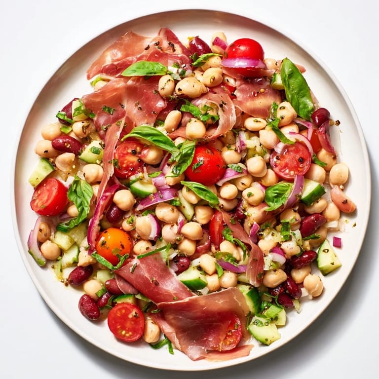 A hearty, gluten-free dense bean salad with prosciutto; imagine the colorful, refreshing ingredients tossed.