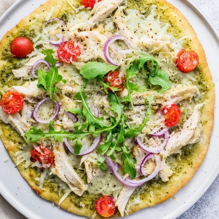 Enjoy the delicious, colorful Pesto Chicken Flatbread, a simple Italian-inspired flatbread recipe.