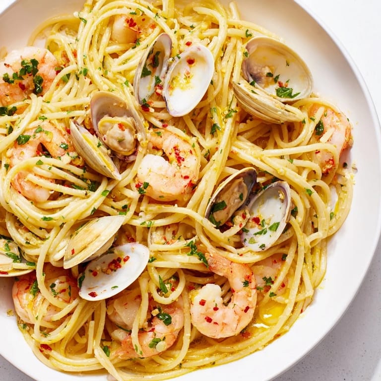 Golden garlic and chili flakes coat the spaghetti in this flavorful Seafood Pasta Aglio e Olio dish.