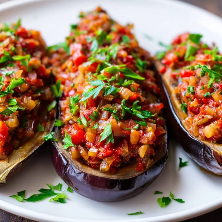 Golden-brown Imam Bayildi, featuring tender eggplant halves and a flavorful tomato and onion stuffing.