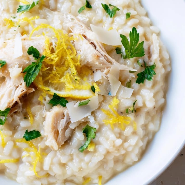 Steaming Smoked Haddock Risotto served with a crisp white wine, perfect for a cozy dinner.