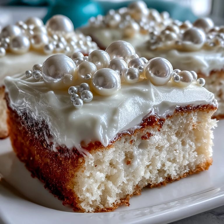 Moist vanilla sheet cake covered in pearl fondant, beautifully finished with edible pearls for a Communion gathering.