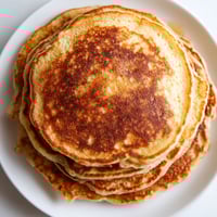 A stack of pancakes on a plate.
