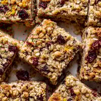 A close up of a square of cereal with raisins.