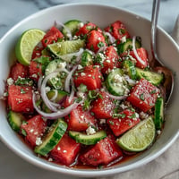 Juicy watermelon cucumber salad with Tajin and lime, perfectly chilled for summer.